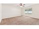 Bright bedroom with a large window offering plenty of natural light and neutral carpet at 703 Elkhorn Fern Ln, Deland, FL 32720