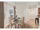 Cozy dining area with a round glass table and seating for four near window at 703 Elkhorn Fern Ln, Deland, FL 32720