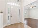 Inviting foyer with tiled flooring and view of a dining room featuring hardwood flooring at 703 Elkhorn Fern Ln, Deland, FL 32720