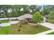 Charming single-story home with manicured lawn, landscaping, and a white fence surrounding the back at 703 Elkhorn Fern Ln, Deland, FL 32720