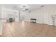 Spacious living room and dining area with tile floors, a decorative light fixture, and neutral paint at 703 Elkhorn Fern Ln, Deland, FL 32720