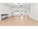 Open living room with neutral tile flooring, plenty of natural light, and a bar area at 703 Elkhorn Fern Ln, Deland, FL 32720