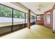 Enclosed patio with screen windows and brick pillars offering backyard views and a ceiling fan for comfort at 703 Elkhorn Fern Ln, Deland, FL 32720