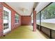 An enclosed brick patio offers an outdoor space to relax and entertain guests with a ceiling fan at 703 Elkhorn Fern Ln, Deland, FL 32720