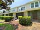 Backyard view featuring a screened-in patio, lush greenery, mature trees and garden at 783 Shropshire Loop, Sanford, FL 32771