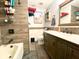 Updated bathroom with vanity, tiled walls, modern fixtures, and combined tub and shower at 783 Shropshire Loop, Sanford, FL 32771