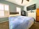 Bright bedroom featuring a large bed, dual windows with shutters, and a mounted TV on the wall at 783 Shropshire Loop, Sanford, FL 32771