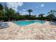 Community pool area with blue lounge chairs, blue skies, and tall palm trees for relaxation at 783 Shropshire Loop, Sanford, FL 32771