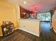 View of kitchen and bar area with stainless steel appliances and dark wood cabinets plus open area to a screened in porch at 783 Shropshire Loop, Sanford, FL 32771