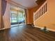 A view of the screened porch area with chairs and light filtering through the screen, and access to the upper floor at 783 Shropshire Loop, Sanford, FL 32771