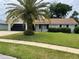 Lovely home with a manicured lawn, complemented by a brick exterior and accented by a mature shade providing palm tree at 808 Scrub Oak St, South Daytona, FL 32119