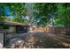 Fenced backyard with mature trees, a screened porch, and a concrete pad at 818 Sugar House Blvd, Port Orange, FL 32129