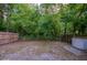 Fenced backyard with mature trees and a storage shed at 818 Sugar House Blvd, Port Orange, FL 32129