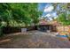Backyard featuring a screened porch, mature trees, and a wood fence at 818 Sugar House Blvd, Port Orange, FL 32129