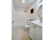 Well-maintained bathroom with a shower-tub combo, neutral tiling, and a white vanity at 818 Sugar House Blvd, Port Orange, FL 32129