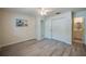 Bright bedroom features wood-look flooring, ceiling fan, and ample closet space at 818 Sugar House Blvd, Port Orange, FL 32129