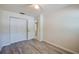 Spacious bedroom with a double closet, neutral paint, and wood-look flooring at 818 Sugar House Blvd, Port Orange, FL 32129