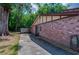 Side view of a brick home featuring a walkway, an exposed AC unit, and connection for a hose at 818 Sugar House Blvd, Port Orange, FL 32129