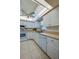 Traditional kitchen with white cabinets, tile flooring, and modern appliances at 818 Sugar House Blvd, Port Orange, FL 32129