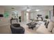 Bright living room featuring modern decor, white furnishings, and tile flooring with a clear view of the dining area at 818 Sugar House Blvd, Port Orange, FL 32129