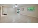 Open living area with tile flooring, lots of natural light, and a view of the entrance and sliding glass door at 818 Sugar House Blvd, Port Orange, FL 32129