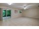 Bright living room with tile floors, leads to a screened porch, windows and neutral-colored walls, inviting and airy feel at 818 Sugar House Blvd, Port Orange, FL 32129