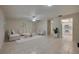 A bright living area with neutral walls, tile flooring, and a glimpse into the kitchen, creating an airy atmosphere at 818 Sugar House Blvd, Port Orange, FL 32129