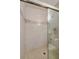 Walk-in shower with glass door, tile surround, and built-in shelving at 818 Sugar House Blvd, Port Orange, FL 32129