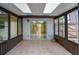 Enclosed sunroom with tile flooring, multiple windows, and sliding glass door at 818 Sugar House Blvd, Port Orange, FL 32129