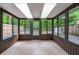 Enclosed sunroom with tile flooring, multiple windows, and outdoor access at 818 Sugar House Blvd, Port Orange, FL 32129