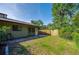 A view of the backyard that is fenced and includes a door to the home at 834 Sugar House Dr, Port Orange, FL 32129