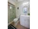 Bright bathroom featuring a glass shower door and modern vanity with a round mirror at 834 Sugar House Dr, Port Orange, FL 32129