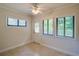 A cozy bedroom with a ceiling fan, neutral walls, tile flooring and natural light at 834 Sugar House Dr, Port Orange, FL 32129