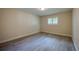 Clean and simple bedroom space with a light wood floor and a window providing natural light at 834 Sugar House Dr, Port Orange, FL 32129