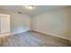 Spacious bedroom with light wood floors, featuring a closet and an additional interior door at 834 Sugar House Dr, Port Orange, FL 32129