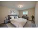Comfortable bedroom with a plush bed, neutral tones, and ample natural light from the window at 834 Sugar House Dr, Port Orange, FL 32129