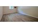 Empty bedroom highlighting the flooring, baseboards, and natural light from the window at 834 Sugar House Dr, Port Orange, FL 32129