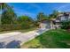 A well-manicured front yard features lush green grass, healthy hedges, and a paved driveway at 834 Sugar House Dr, Port Orange, FL 32129