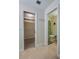 Hallway view of closet and adjacent bathroom with shower and toilet at 834 Sugar House Dr, Port Orange, FL 32129