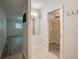 Hallway with walk-in closet, mirror, and view of a bedroom with light wood flooring and blinds at 834 Sugar House Dr, Port Orange, FL 32129