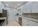 Updated kitchen features stainless steel appliances and granite countertops with bright white cabinetry at 834 Sugar House Dr, Port Orange, FL 32129