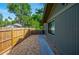 Side yard with a wooden fence and gravel, offering privacy and low-maintenance landscaping at 834 Sugar House Dr, Port Orange, FL 32129