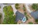 Aerial view of the property showcasing the house, pool, driveway and mature trees on a large lot at 9720 Fairway Cir, Leesburg, FL 34788