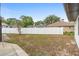 Spacious fenced backyard featuring a well-maintained lawn, offering privacy and room for outdoor activities at 9720 Fairway Cir, Leesburg, FL 34788