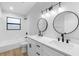 Bright bathroom with double sinks, a bathtub and new fixtures at 9720 Fairway Cir, Leesburg, FL 34788