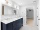 Bathroom featuring a double sink vanity with marble countertops and a gold-framed mirror at 9720 Fairway Cir, Leesburg, FL 34788
