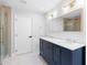 Bathroom featuring a double sink vanity with marble countertops and a gold-framed mirror at 9720 Fairway Cir, Leesburg, FL 34788