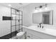 Modern bathroom featuring black framed shower, white subway tile and vanity with a black faucet at 9720 Fairway Cir, Leesburg, FL 34788