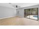 Spacious bedroom with sliding glass doors that lead to a screened in pool at 9720 Fairway Cir, Leesburg, FL 34788