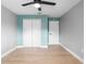 Bedroom featuring wood-look floors, neutral paint, ceiling fan, and closet at 9720 Fairway Cir, Leesburg, FL 34788